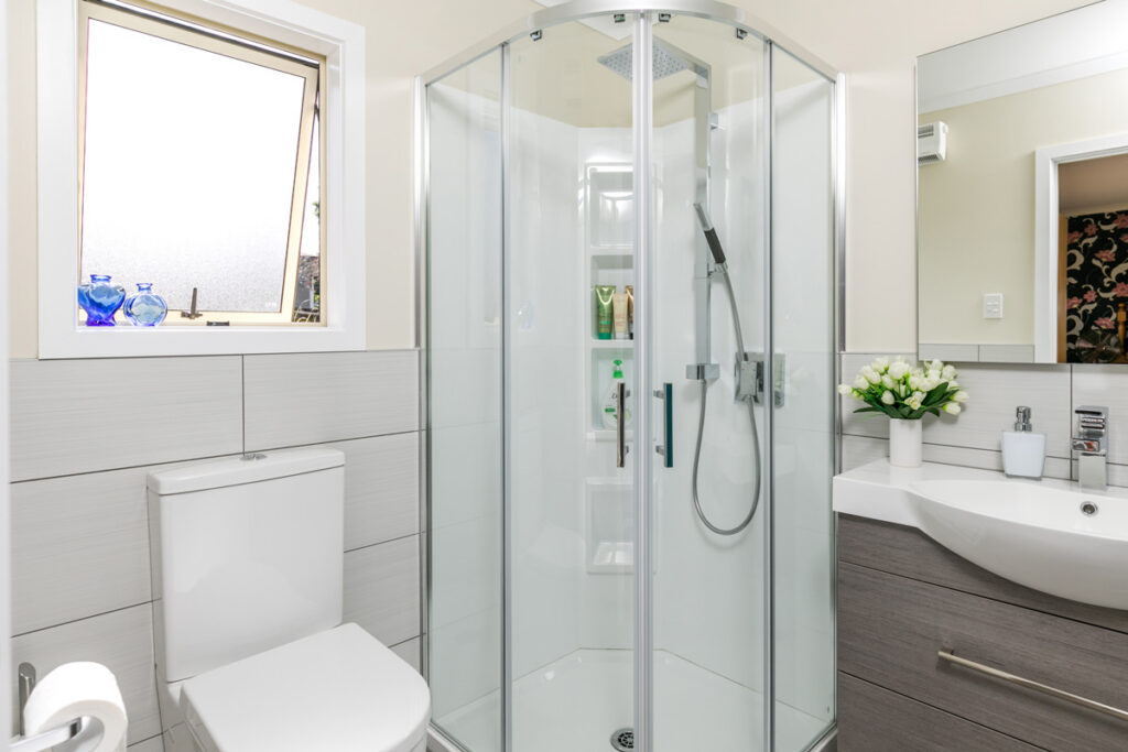 Compact bathroom with quadrant shower, toilet and vanity