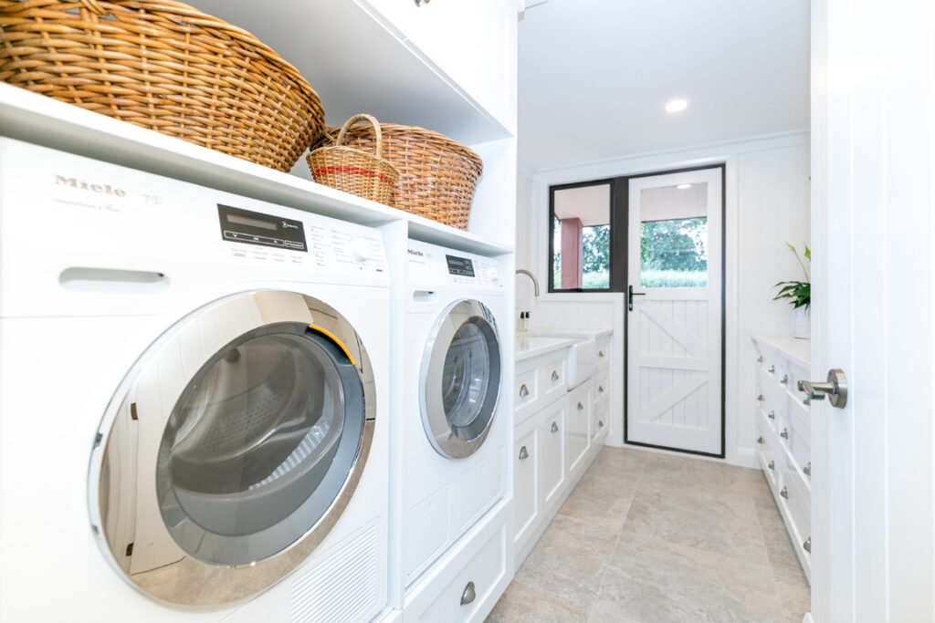 Renovated laundry with washer, dryer and storage baskets