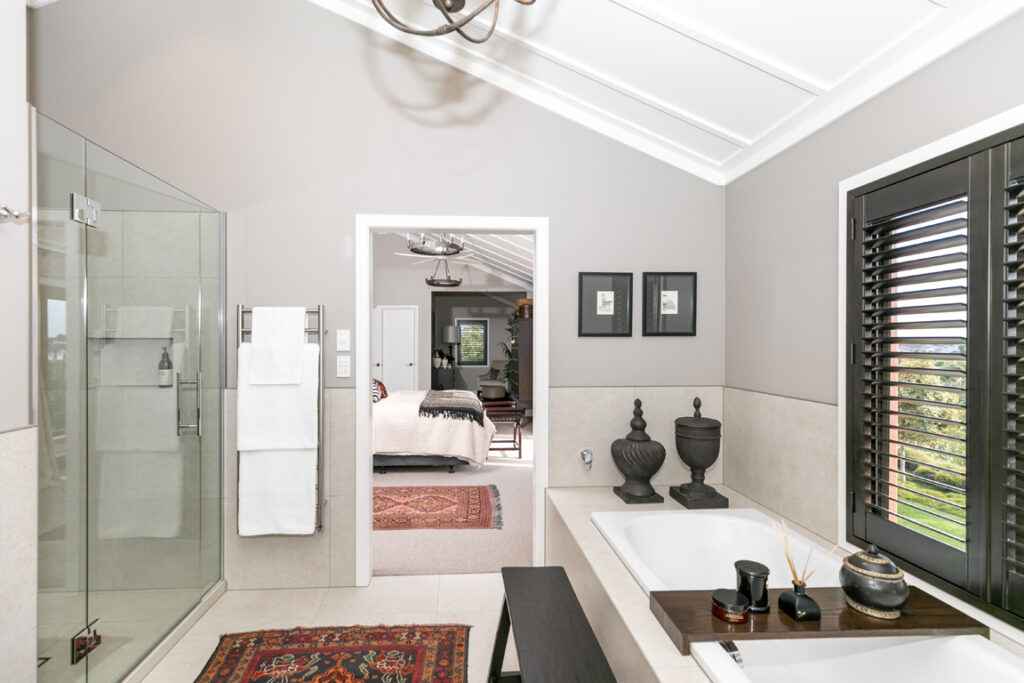 Luxury ensuite shower and towel rail seen from the bedroom